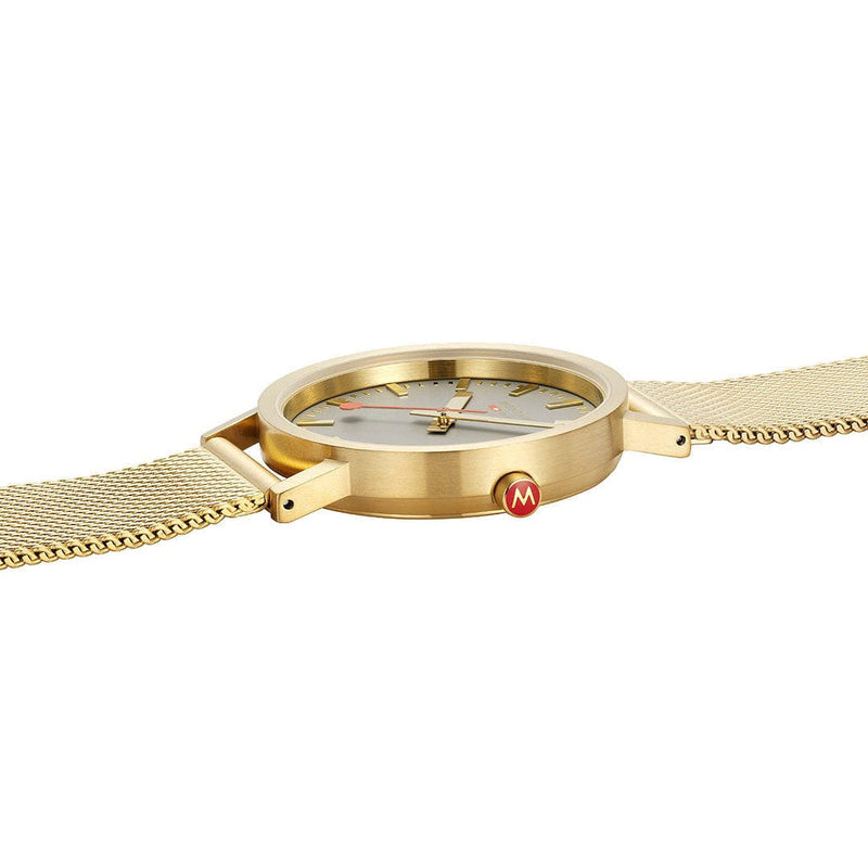 Gold-toned wristwatch with a minimalist round face and mesh band.