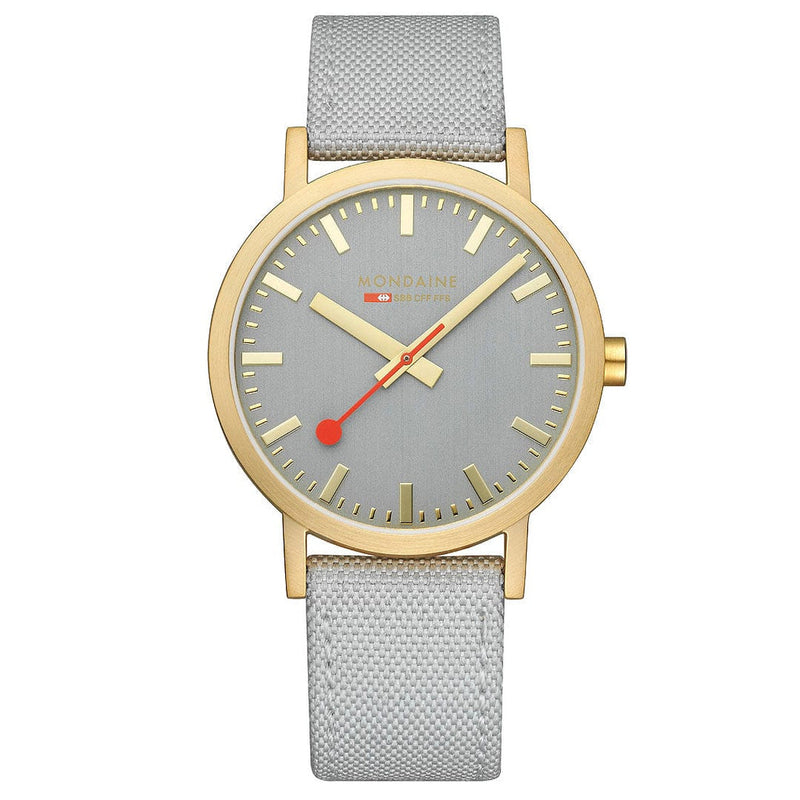 Wristwatch with a gold-tone case, gray dial, and light gray fabric strap.