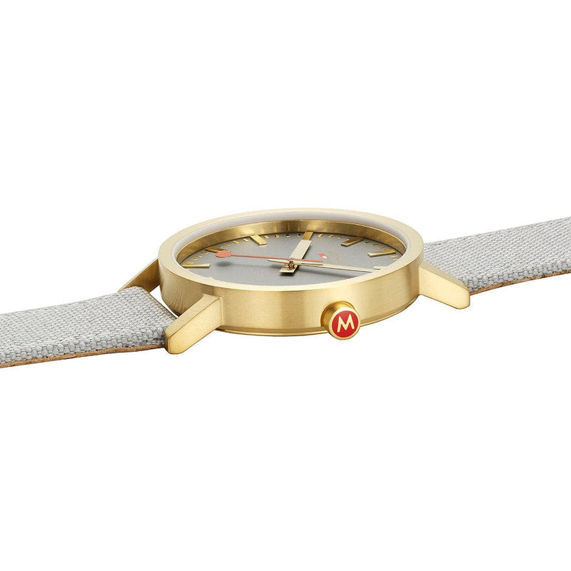 Gold-toned wristwatch with a white leather strap and minimalist dial design.