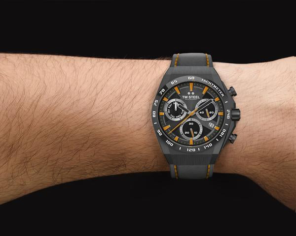 Stylish sports chronograph wristwatch with a black and yellow dial on a gray strap.