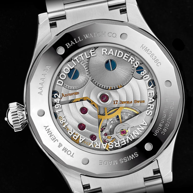 Intricate mechanical watch movement with visible gears and jewels.