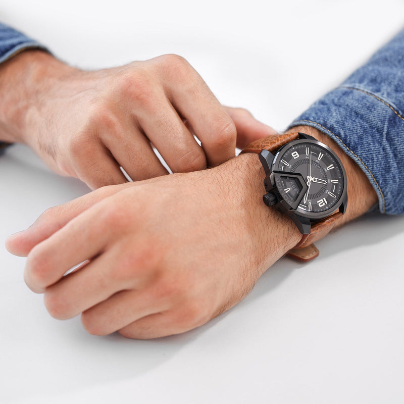 Wristwatch with a round black face and brown leather strap.