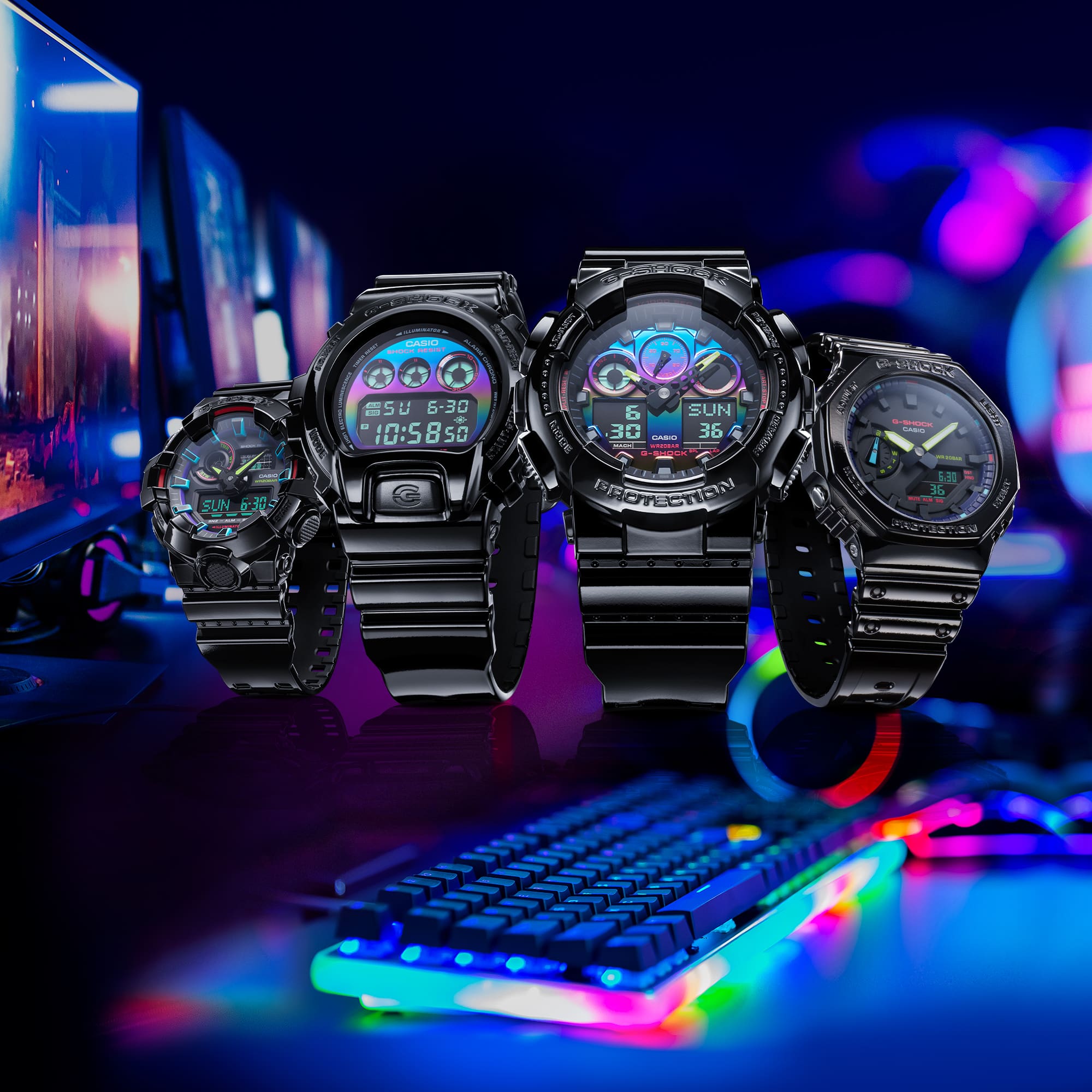 Four black digital wristwatches with colorful displays arranged in a row.