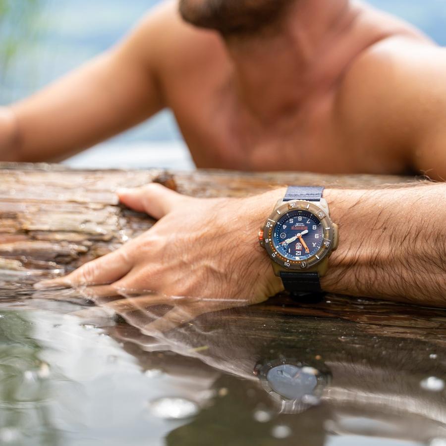 Luminox Bear Grylls Survival Eco Series 3703 showcased on a wrist near water, highlighting its rugged design.