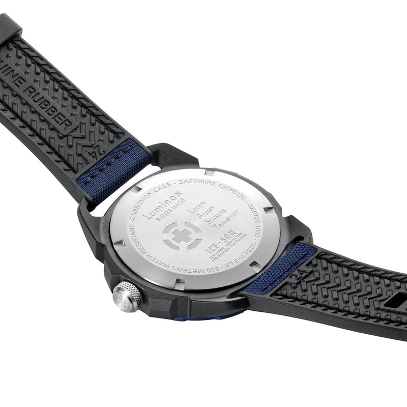 Wristwatch with a black and blue strap and silver caseback visible.