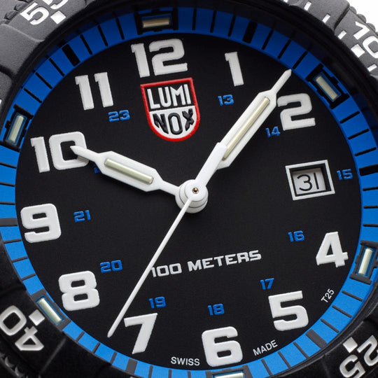 Luminox wristwatch face with a black dial, blue bezel, and white numerals.