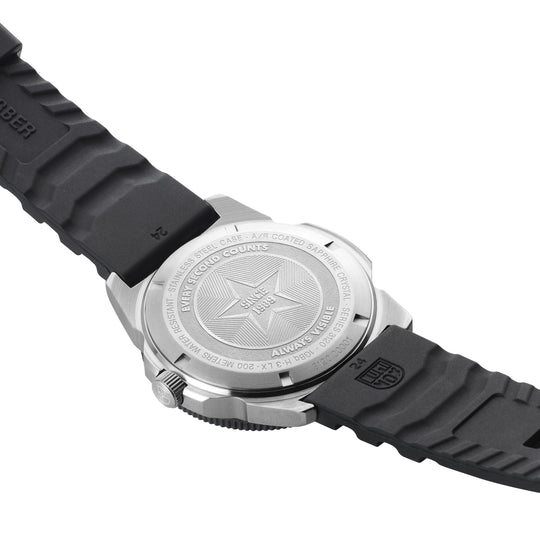 Wristwatch with a black rubber strap and silver-colored case back featuring a star design.