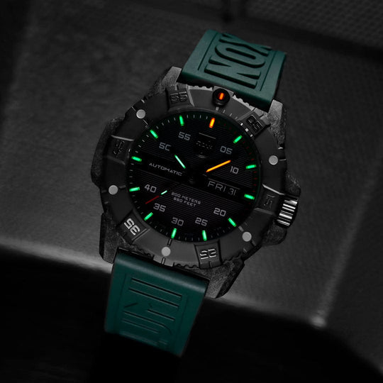 Rugged sports watch with a black face and green rubber strap.