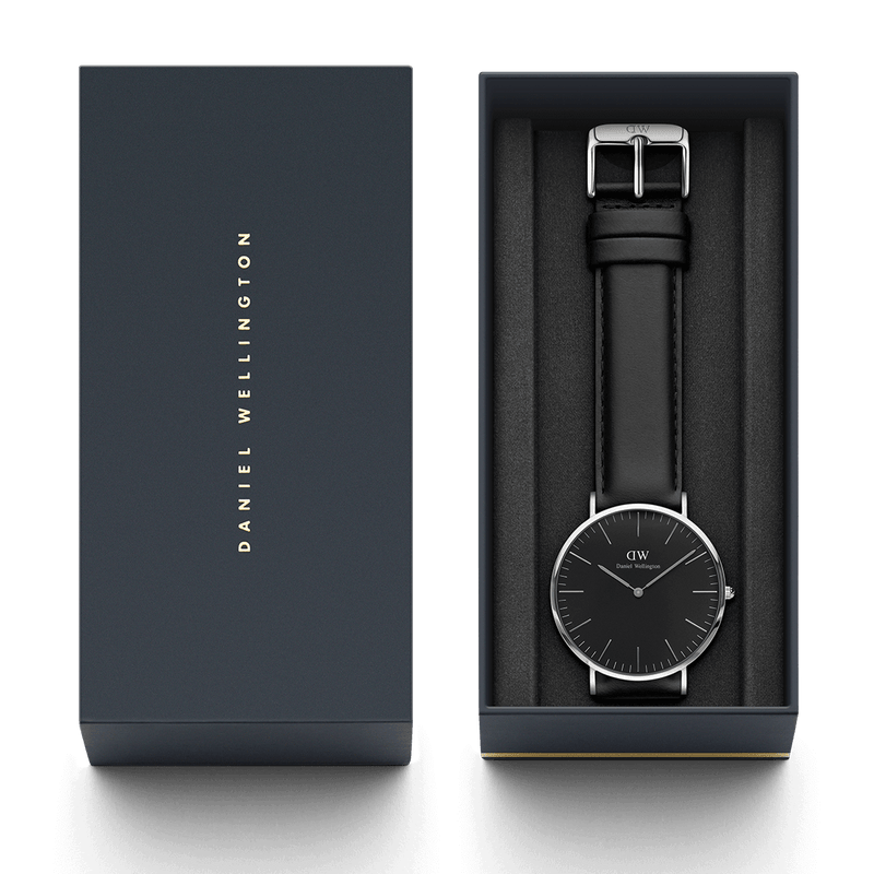 Sleek black wristwatch with silver accents in an open gift box.