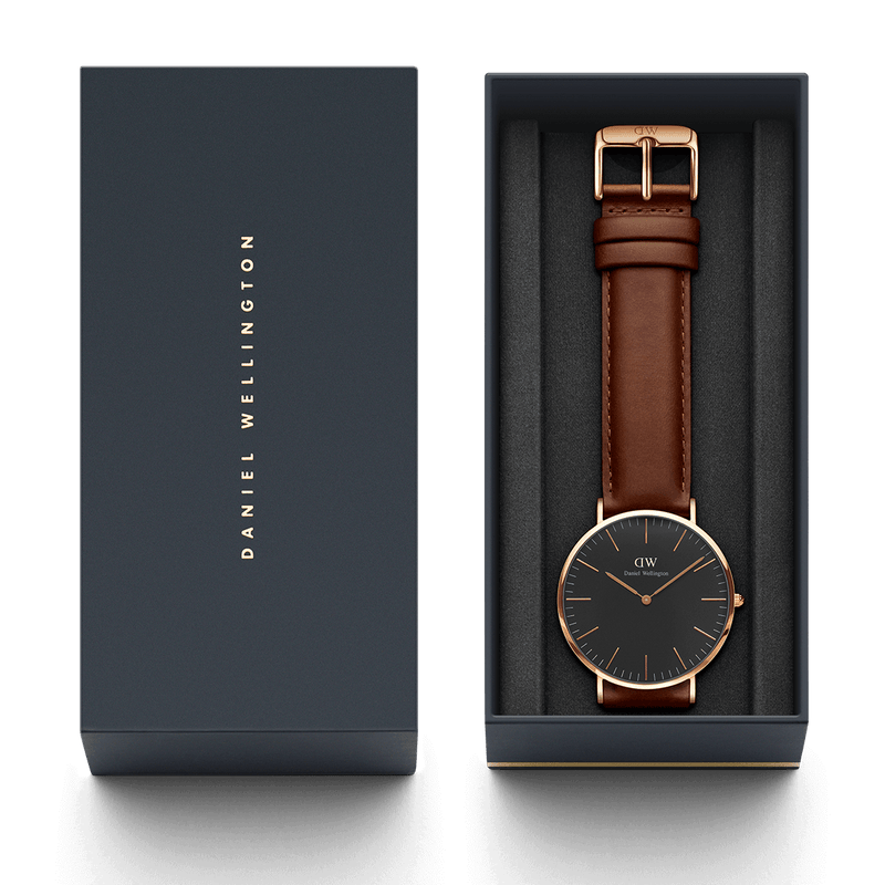 Elegant wristwatch with a brown leather strap and black face in a gift box.