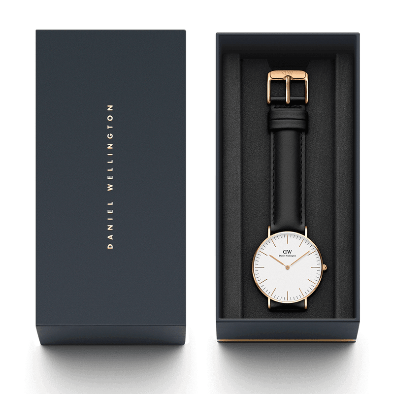 Elegant wristwatch with a white face, gold accents, and black leather strap in a gift box.