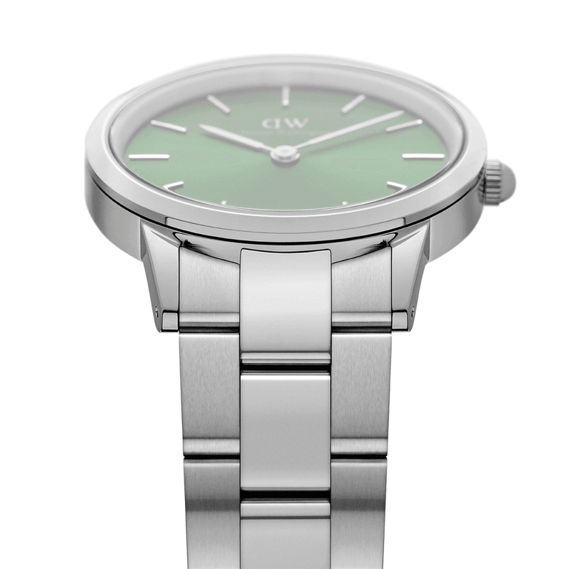 Stainless steel wristwatch with a round face and mint green dial.